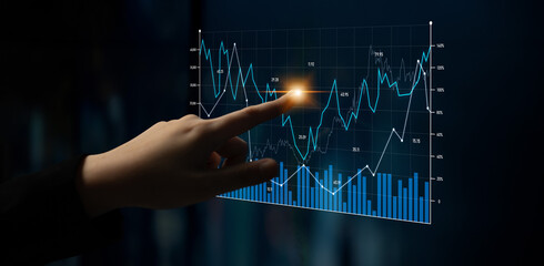A business professional uses a touchscreen to interact with a futuristic data analytics chart, showcasing key metrics and trends in a modern office setting. Scalp