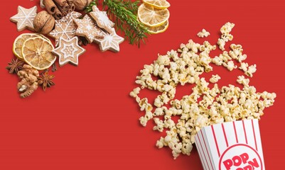 Spilt tasty salt Popcornon and christmas sweet the desk