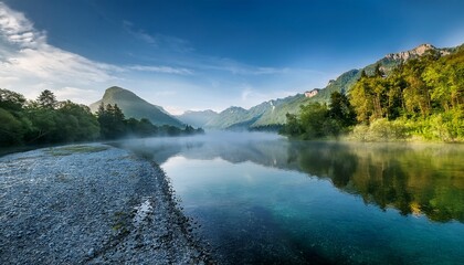 Fototapeta premium morning fog a tranquil river beneath mountain peaks