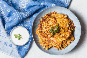 Potato pancakes Latkes on white table background. Traditional Jewish festive food for Hanukkah holiday. Jew festival of lights. Flat lay, top view.