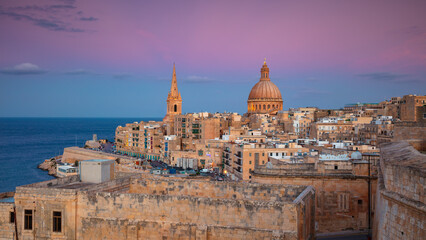 Valletta, Malta. Cityscape image of historical old town of Valletta, Malta with Basilica of Our Lady of Mount Carmel at beautiful autumn sunset.