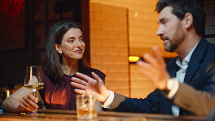 Elegant couple talking bar counter evening closeup. People flirting night club