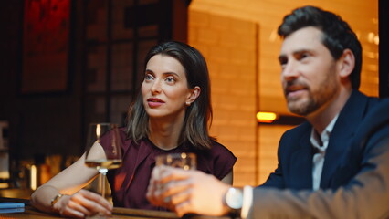 Elegant people speaking waiter ordering drinks at nightclub closeup. Pair rest