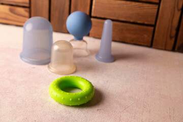 Bright Green Teething Ring With Baby Accessories On Soft Pink Surface For Infant Care and Play