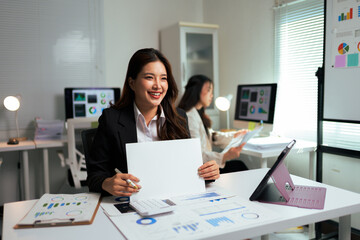 Asian businesswoman showing blank sign during office presentation