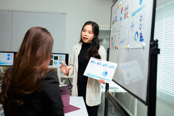Businesswoman giving analysis presentation in modern office meeting