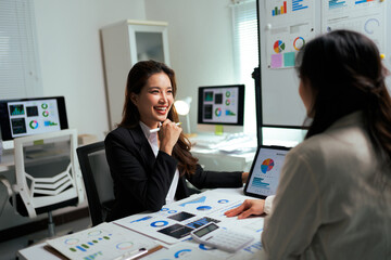 Businesswomen discussing data analysis during corporate meeting