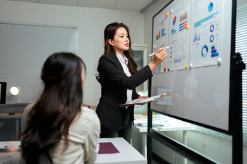 Businesswoman presenting data analysis charts during office meeting