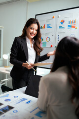 Businesswoman presenting data charts during office meeting