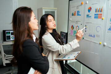 Businesswomen discussing data analysis during office presentation