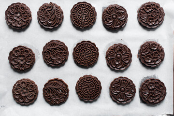 Overhead view of stamped chocolate cookies on a parchment lined tray