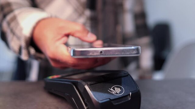 Customer making contactless payment with smartphone