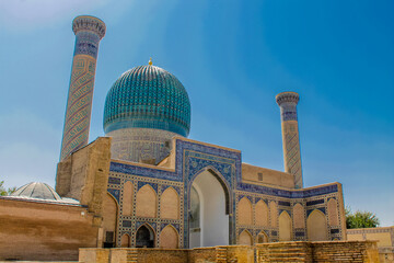 Uzbekistan architecture in Samarkand and Bukhara with intricate mosaics blue domes ancient madrasas Islamic patterns historic monuments vibrant tilework and cultural heritage in bright daylight