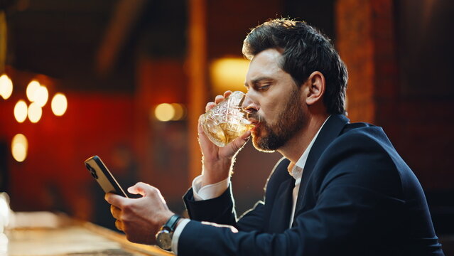 Stylish guy waiting bar sipping whiskey checking phone closeup. Lady joining man - Powered by Adobe