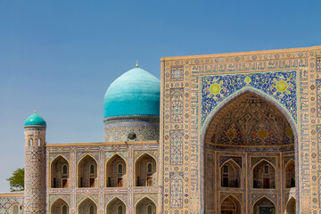 Uzbekistan architecture in Samarkand and Bukhara with intricate mosaics blue domes ancient madrasas Islamic patterns historic monuments vibrant tilework and cultural heritage in bright daylight