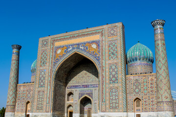 Uzbekistan architecture in Samarkand and Bukhara with intricate mosaics blue domes ancient madrasas Islamic patterns historic monuments vibrant tilework and cultural heritage in bright daylight