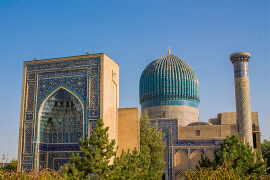 Uzbekistan architecture in Samarkand and Bukhara with intricate mosaics blue domes ancient madrasas Islamic patterns historic monuments vibrant tilework and cultural heritage in bright daylight