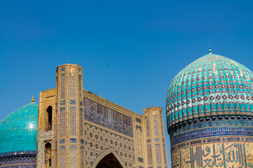 Uzbekistan architecture in Samarkand and Bukhara with intricate mosaics blue domes ancient madrasas Islamic patterns historic monuments vibrant tilework and cultural heritage in bright daylight