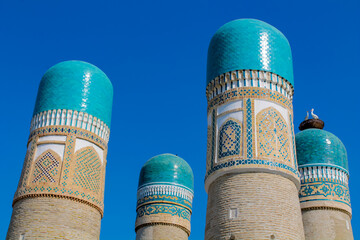 Uzbekistan architecture in Samarkand and Bukhara with intricate mosaics blue domes ancient madrasas Islamic patterns historic monuments vibrant tilework and cultural heritage in bright daylight