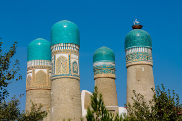 Uzbekistan architecture in Samarkand and Bukhara with intricate mosaics blue domes ancient madrasas Islamic patterns historic monuments vibrant tilework and cultural heritage in bright daylight