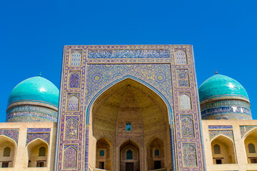 Uzbekistan architecture in Samarkand and Bukhara with intricate mosaics blue domes ancient madrasas Islamic patterns historic monuments vibrant tilework and cultural heritage in bright daylight