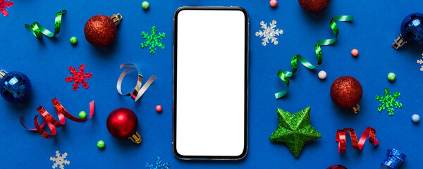 Christmas online shopping from home phone with blank white display top view. smart mobile with copy...
