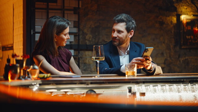 Laughing lovers talking bar relaxing together at evening closeup. Happy couple - Powered by Adobe