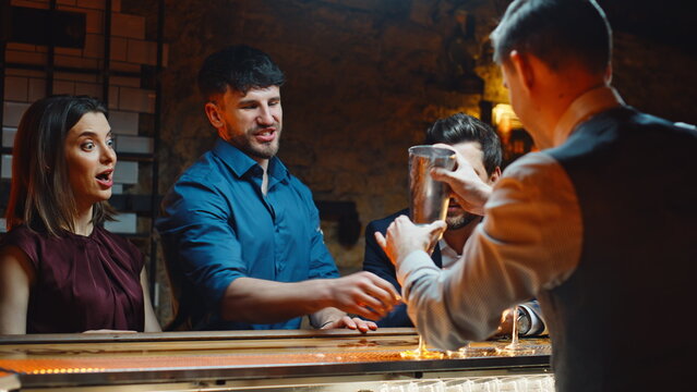 Partying friends resting bar having fun closeup. Barista preparing cocktails