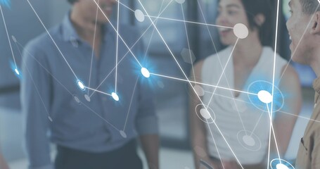 Discussing three coworkers in business casual holding device while viewing hologram in office