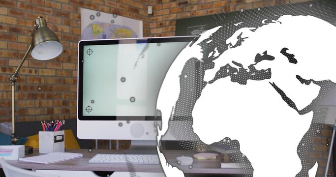 Showing white all-in-one desktop on wooden desk at home office, with globe graphic overlay - Powered by Adobe