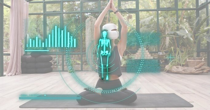 Sitting cross-legged woman wearing VR or AR headset and black on mat in glass studio, with AR overla - Powered by Adobe