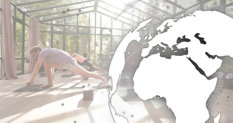 Doing deep lunges, four adults in workoutwear in glass studio with mats, blocks, globe, copy space © vectorfusionart