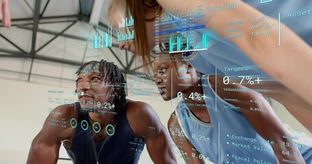 Leaning group of five focusing on AR financial charts in sports hall, wearing tank tops