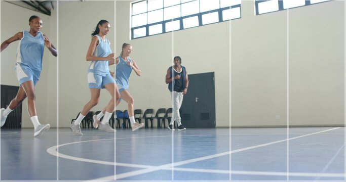 Running four players in light blue uniforms jogging on blue court with white lines, coach observing - Powered by Adobe
