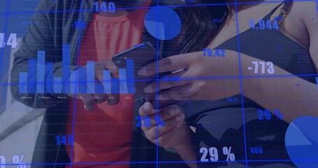 Reviewing colleagues viewing phone with data overlay 29% charts at desk, red top, black strappy top