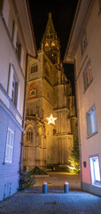 Illuminated cathedral &ldquo;M&uuml;nster unserer lieben Frau&rdquo; (Cathedral of Our Lady), photographed from an alleyway at night. Konstanz, Baden-W&uuml;rttemberg, Germany.