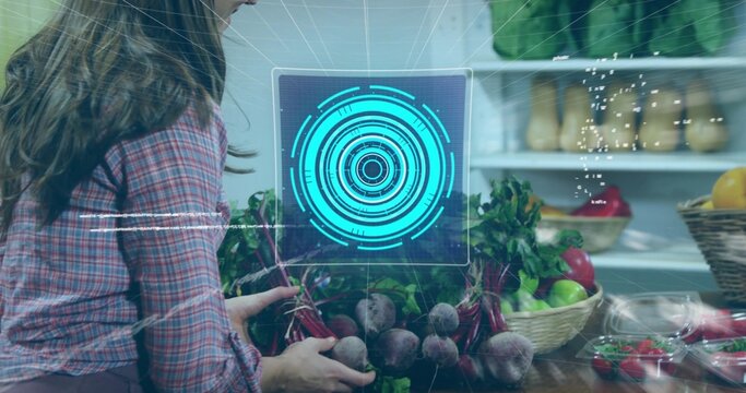 Woman in pink plaid shirt handling beets with greens at kitchen counter, teal UI, copy space - Powered by Adobe