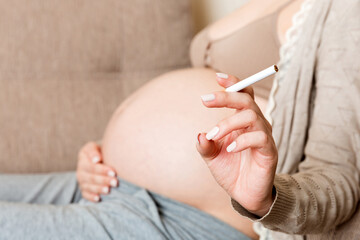 Pregnant woman with cigarette at home. mother smoking concept