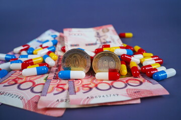 Different capsules, tablets and tenge banknotes. Rising drug prices. Quotas, subsidizing medical care.