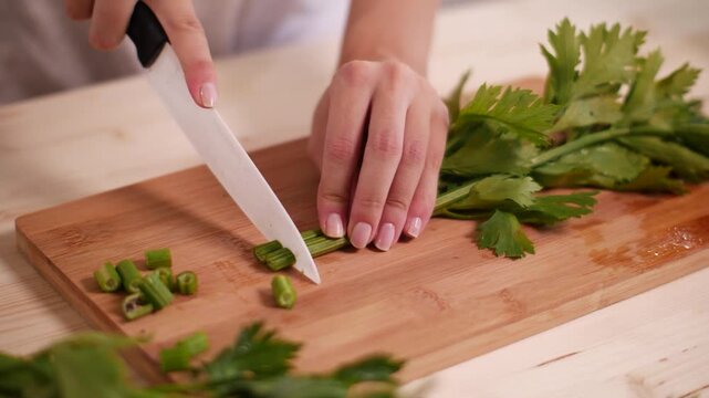 Woman cutting celery making a fit salade