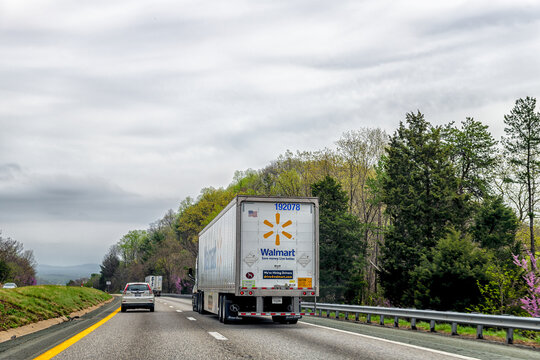 Crozet, USA - April 5, 2025: Spring forest season with redbud trees in Virginia Blue Ridge highway i64 and walmart truck