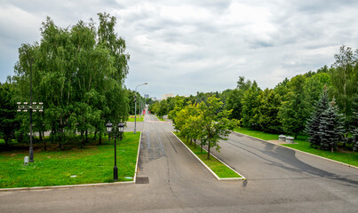 Wide Alley With Lush Trees And Lampposts in Victory Park on Poklonnaya Hill, Moscow, Russia, 10 August 2025