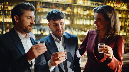 Drunk colleagues making selfie raising alcohol shots closeup. People celebrating
