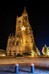 During the Christmas season, illuminated stars hang in front of the M&uuml;nster unserer lieben Frau's illuminated tower walls, which shine at night. Constance, Baden-W&uuml;rttemberg, Germany.