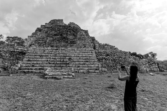 woman standing in front of ancient mayan pyramid ruins in the maya city of oxkintok in yucatan mexico (travel tourism photo blog adventure destination history tour getaway) steps historic monument
