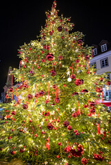 Beautifully decorated Christmas tree with red baubles in the market square at night. Konstanz, Baden-W&uuml;rttemberg, Germany.