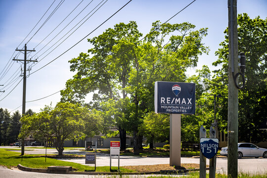 Nellysford, USA - April 27, 2025: Virginia countryside small town in Nelson county with sign for Remax mountain valley properties and Wells Fargo bank