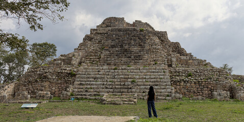woman standing in front of ancient mayan pyramid ruins in the maya city of oxkintok in yucatan mexico (travel tourism photo blog adventure destination history tour getaway) steps historic monument