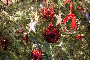 Closeup of beautifully decorated Christmas tree with red baubles at night. Konstanz, Baden-W&uuml;rttemberg, Germany.