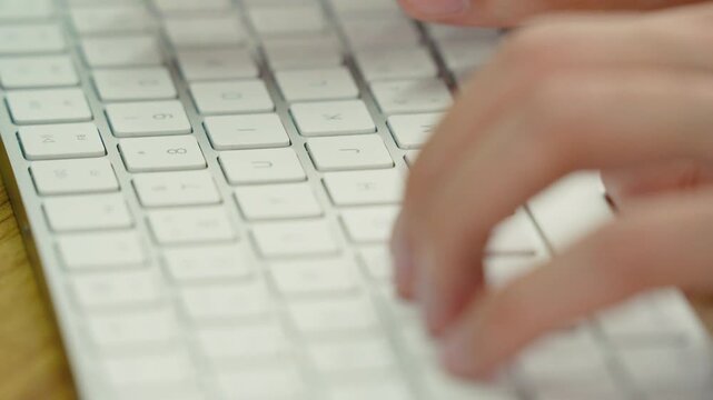 Programmer hands typing on white keyboard close-up keyboarding coding computer work